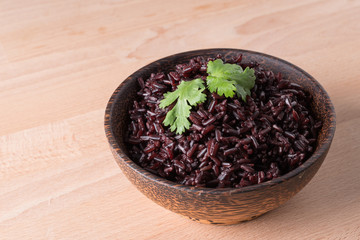 Steamed rice berry on wood bowl wood background