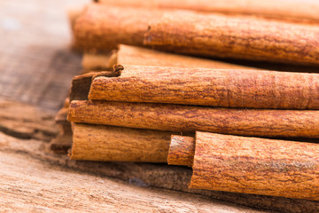 Cinnamon on wooden background