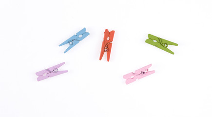 Colored clothespins on a white background