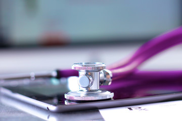 Stethoscope with a tablet computer lie on a table