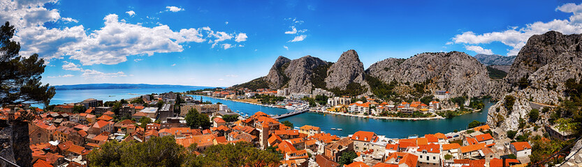 Naklejka na ściany i meble Panoramic view of the Omis on Adriatic sea surrounded by high mountains with amazing canyon of river Cetina, Dalmatia, Croatia.