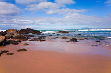Fototapeta na wymiar Rocks on sandy beach at Port Macquarie Australia