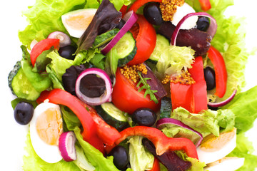 salad from fresh vegetables in a plate on a table, selective focus