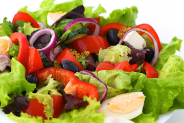 salad from fresh vegetables in a plate on a table, selective focus