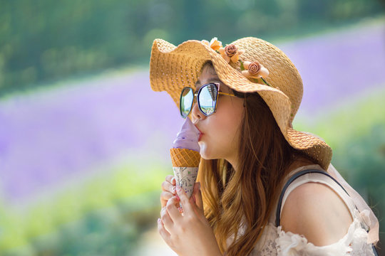 A Girl eating Ice Cream at Lavender Field in Hokkaido Japan
