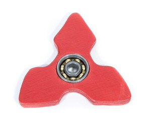 Red fidget spinner stress relieving toy on white background