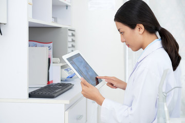 Doctor workig on tablet computer