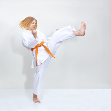 Blow leg girl is training with an orange belt