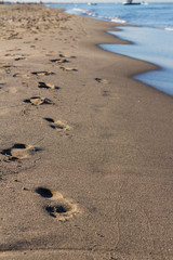 Sand footprints by the sea