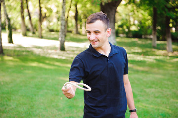 Outdoor games - guy playing ring toss in a park.