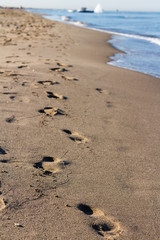 Footprints in the sand by the sea