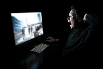 Young gamer in the dark