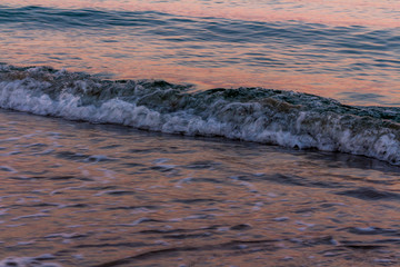 Wave at sunrise colours