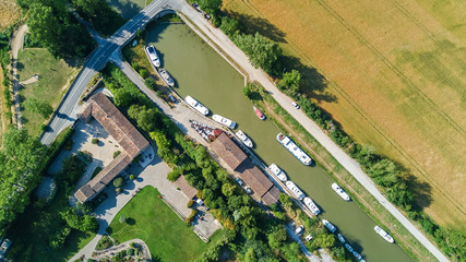 Aerial top view of boats in Canal du Midi from above, family travel by barge and vacation in...