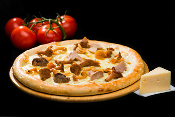 selective focus on classic appetizing Italian fresh cheese pizza with different types of mushrooms on wooden round board on dark background, near tomatoes and cheese