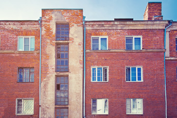 Facade of an old red brick high-rise building