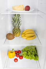 Open fridge full of fresh fruits and vegetables