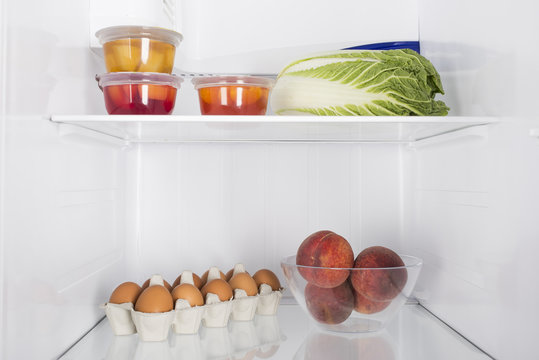 Open fridge full of fresh fruits and vegetables