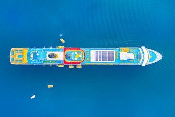 Top view of a colorful cruise liner in the blue sea