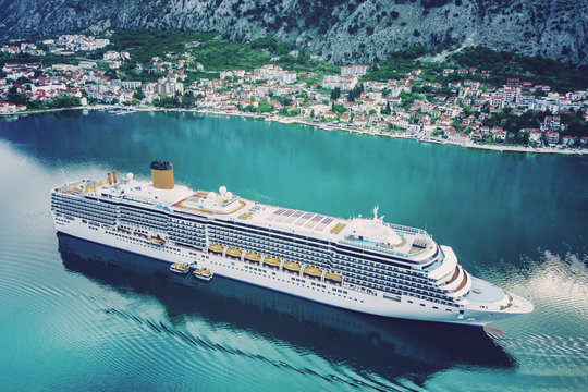 Beautiful white cruise ship in the bay, top view