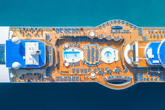 Cruise ship with chaise lounges and a swimming pool, top view