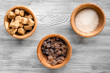 lumps and sanding sugar for sweets on gray kitchen table background top view