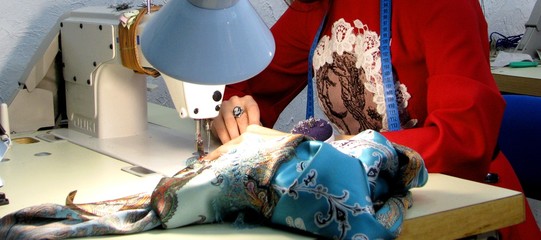Girl's hand at the sewing machine
