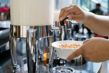 Cereals and fresh maik on the table in buffet breakfast in the restaurant. Healthy food.