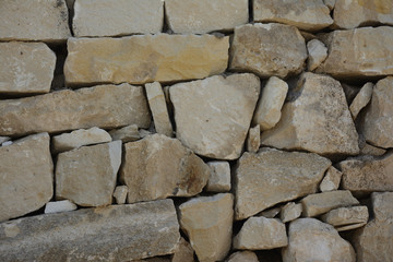 Wall of old stones with cracks texture background