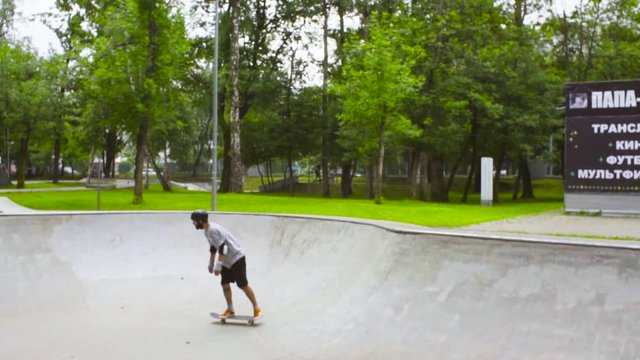 Young man skateboarding at outdoor skate park