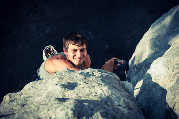 Men climbs a rock and makes hard move and shoe emotions