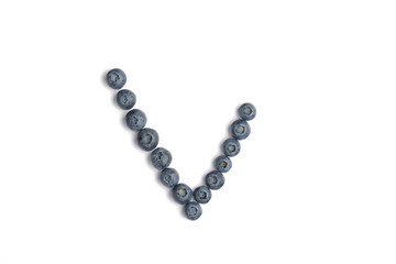 Summer blueberry for checkbox, top view. Yes tick sign symbol mark made of Ripe bilberry or blueberry over isolated white background