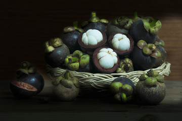 mangosteen on plate and chopping board on the wooden flor