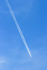 Contrails track on the blue sky