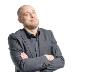 Smiling bald man in a gray suit with arms crossed. Isolated