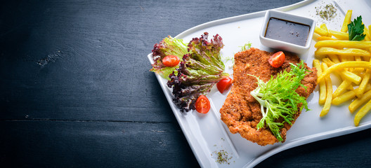 Chopped pork with fresh vegetables. On a wooden background. Top view. Free space for your text.