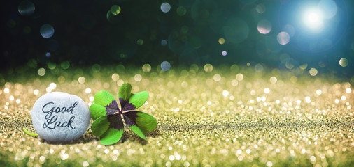 Abstract background with four leaf lucky clover and stone