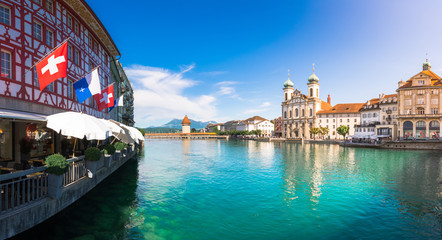 Panoramic view of historic Zurich city center with famous Fraumunster, Grossmunster and St. Peter and river Limmat at Lake Zurich on a sunny day with clouds in summer, Canton of Zurich, Switzerland - obrazy, fototapety, plakaty