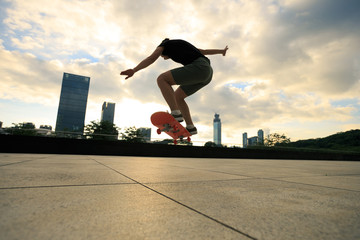 Woman practicing with skateboard at sunrise city © lzf