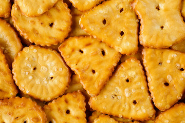 Baked, salted tasty mini pretzels in different shapes. Macro food texture background