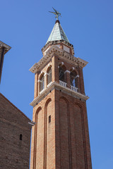 Fototapeta na wymiar Bell tower near cathedral dedicated to St. Mary of the Assumption in Chioggia