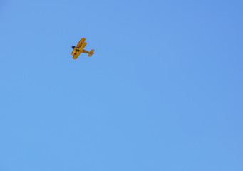 vintage airplane in flight . at empty blue sky