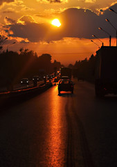 Fototapeta na wymiar Highway cars driving into the sunset. Blur.