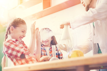 Funny teacher puffing smoke on his pupils