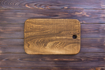 vintage cutting board with space for text on old wooden background, close-up