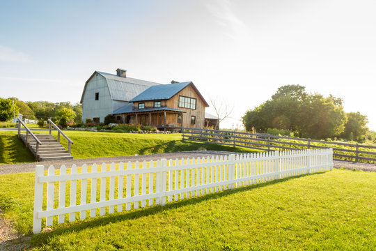 White picket fence and farmhouse