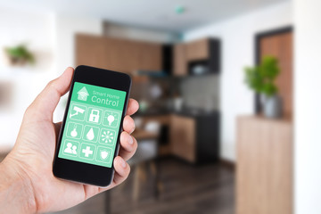 Hand using smartphone to smart home app on mobile for remote control everything in home by wifi network.