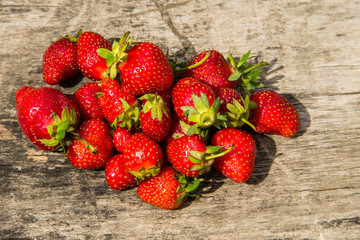 Ripe fresh strawberries on rustic wooden background. Top view