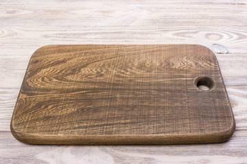 top view of wooden cutting board on old wooden table