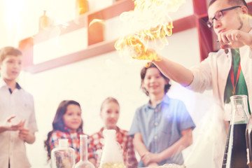 Serious analyst showing experiment with fire